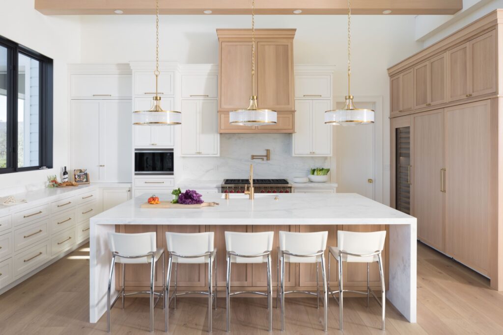 santa rosa kitchen with calacatta caldia white marble on backsplash and waterfall island