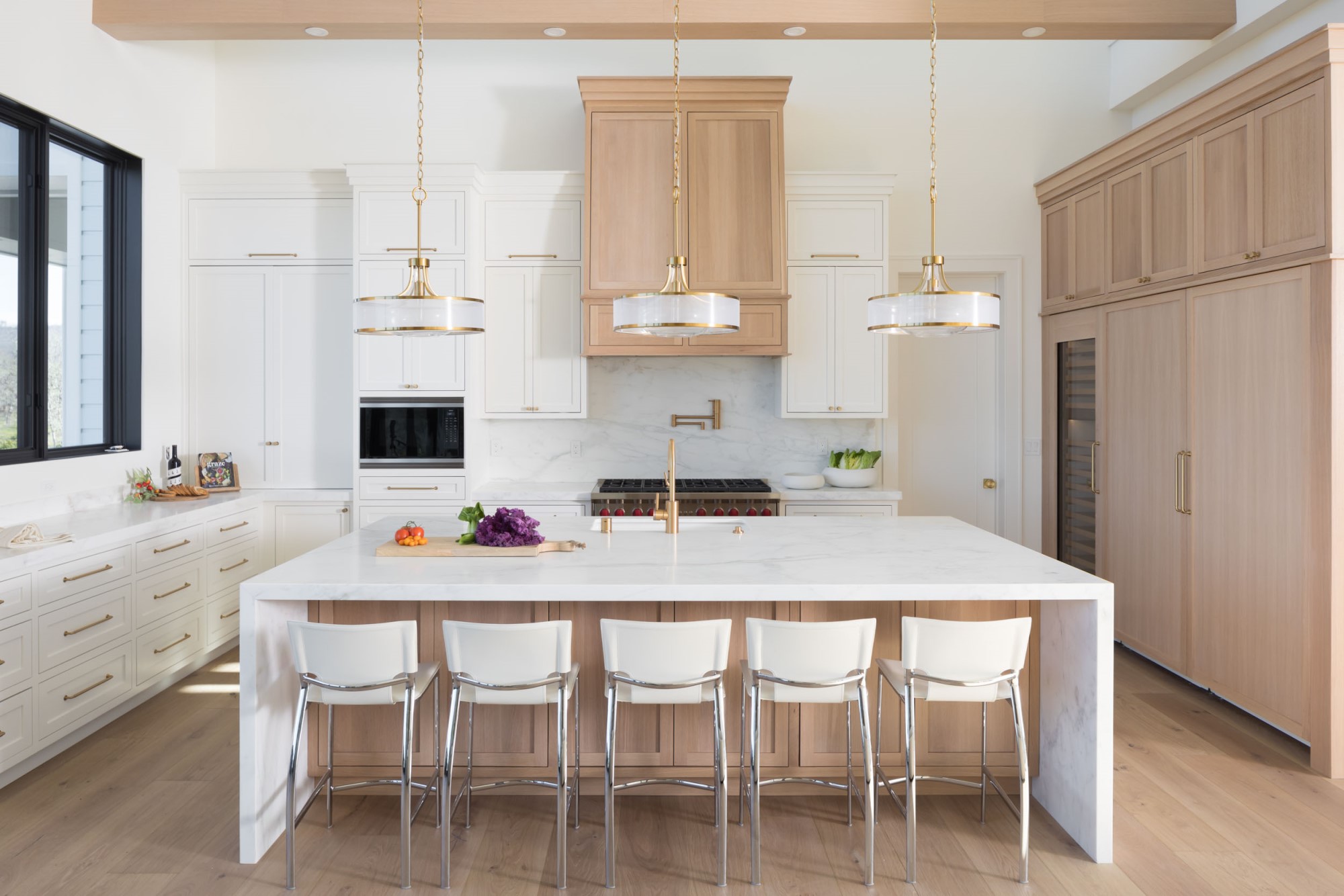 santa rosa kitchen with calacatta caldia white marble on backsplash and waterfall island