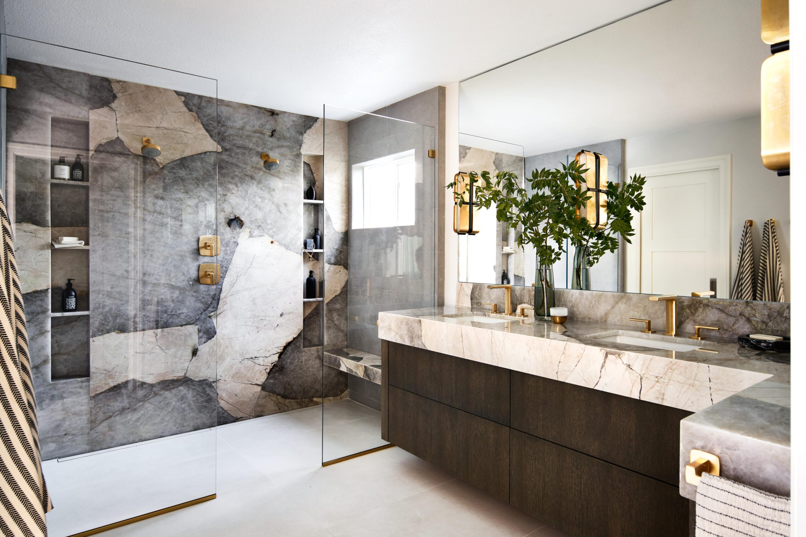 primary bathroom with patagonia quartzite installed on large shower wall and vanity